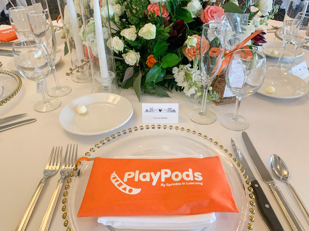 Orange PlayPod on a dinner place setting at a wedding reception