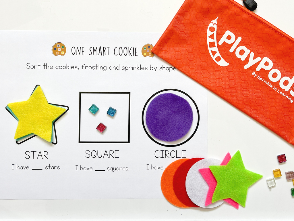 Orange PlayPod, instruction card and different texture play pieces