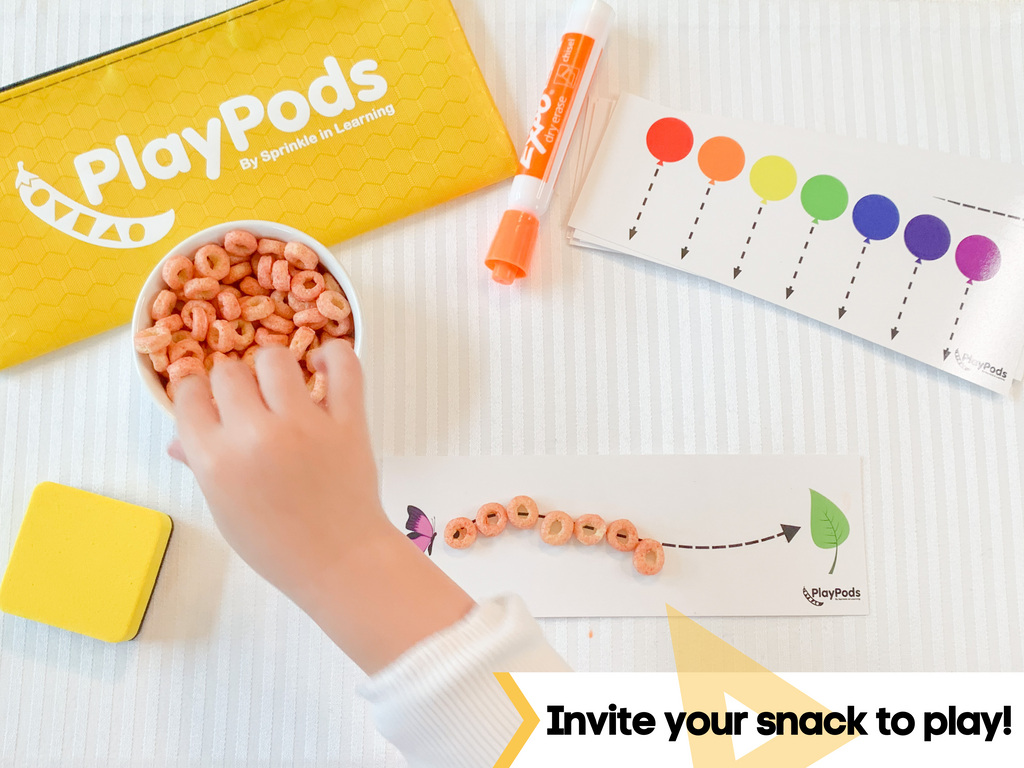 Childs using cereal to follow the lines on a card.