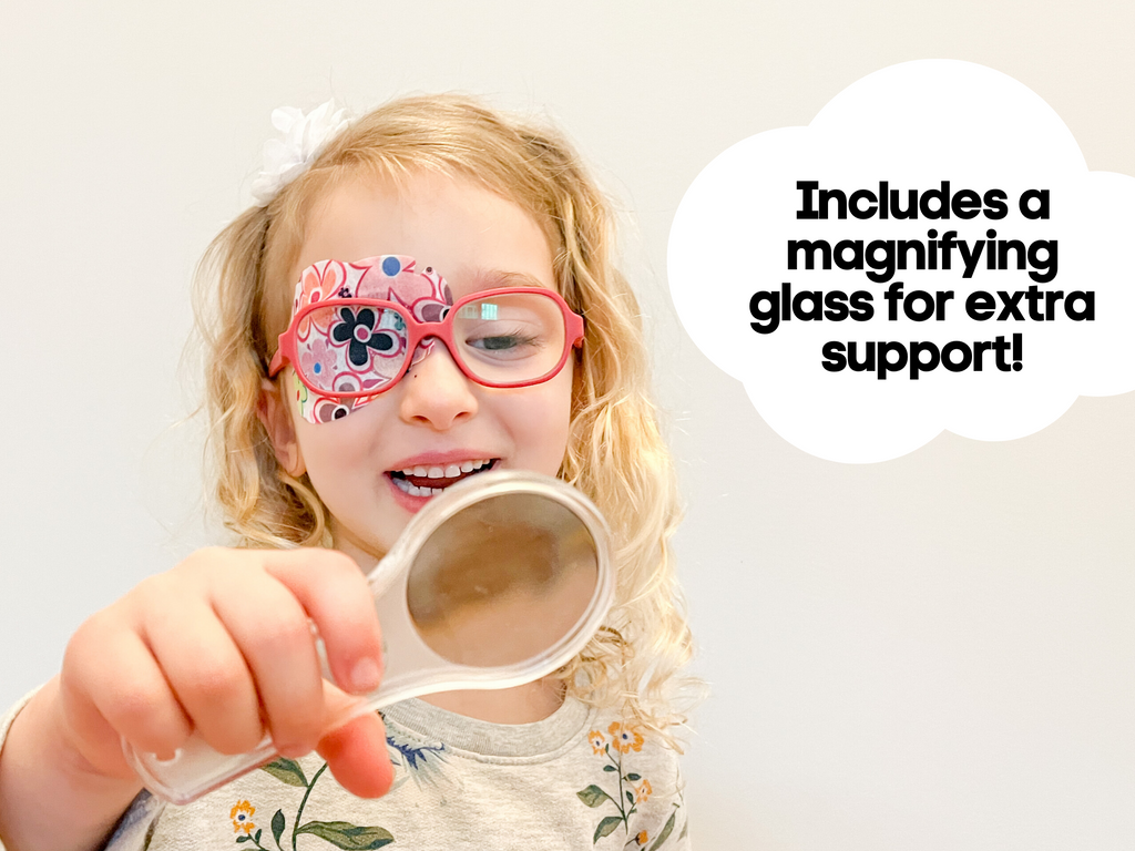 Girl with glasses using magnifying glass