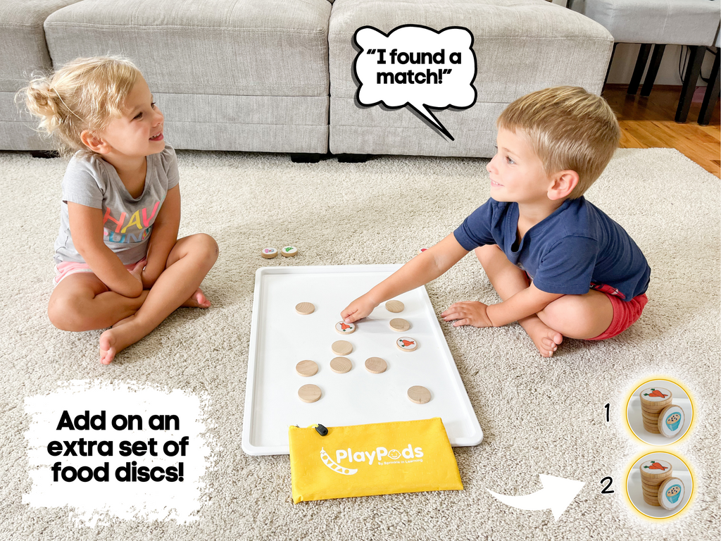 Little girl and boy playing matching games with food image discs