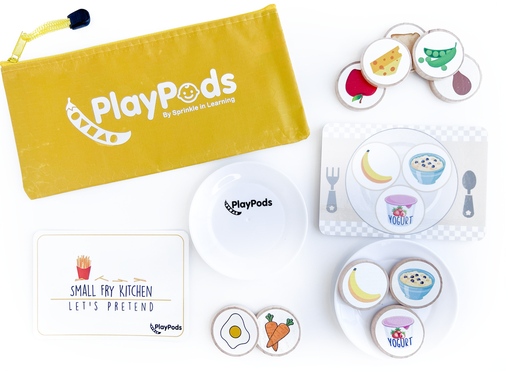 Yellow PlayPod with white plastic plate and wooden discs with food images on them
