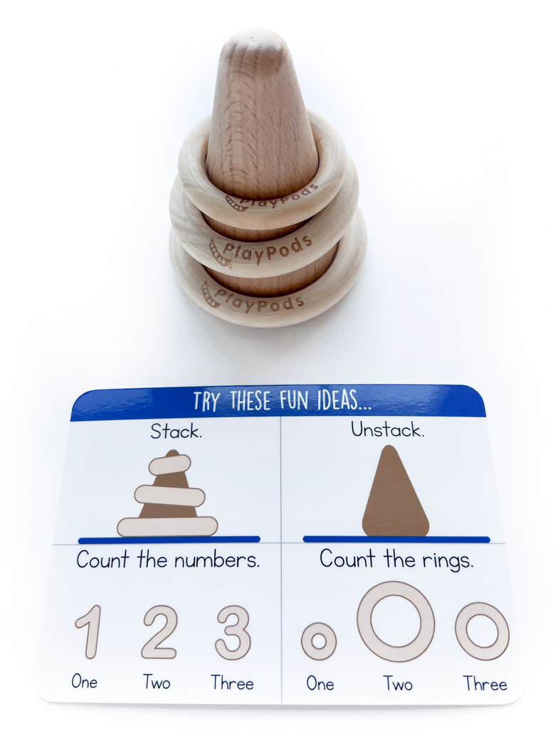Wooden rings stacked on wooden cone with instruction card
