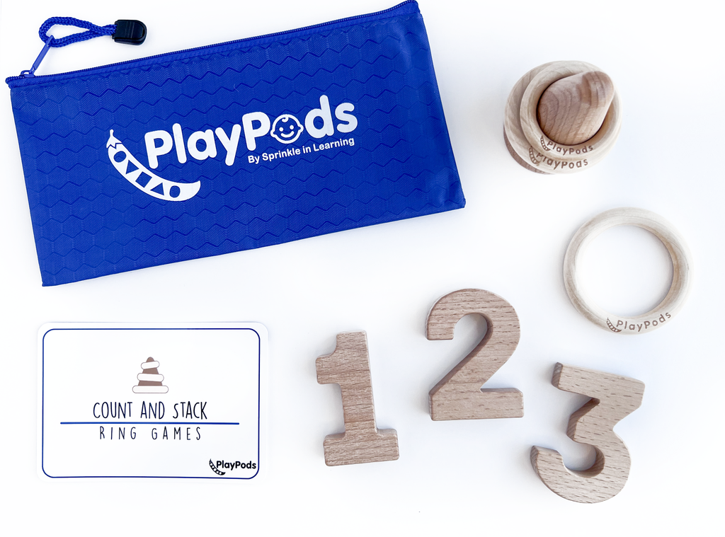 Blue PlayPod pouch, wooden numbers, and wooden stacking game on a white background